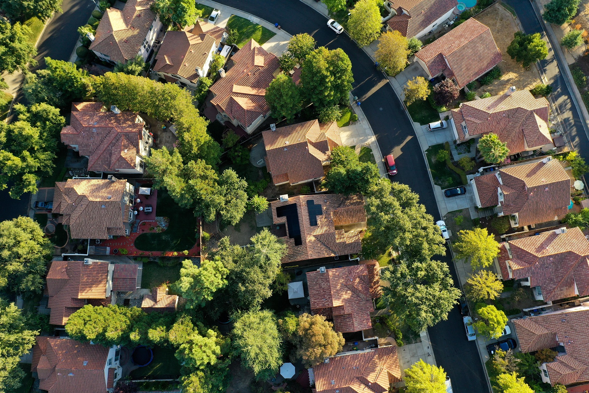 An aerial view of a suburban neighborhood of houses and streets